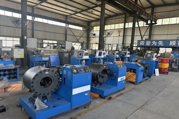 Multiple hydraulic crimping machines neatly arranged in a production facility, showcasing advanced equipment