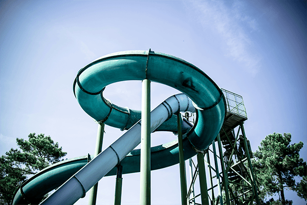 Green water slide with steel supports, Durable piping for recreational water systems