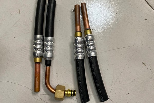 Crimped hydraulic hoses with metal fittings, demonstrating strong and leak-proof connections