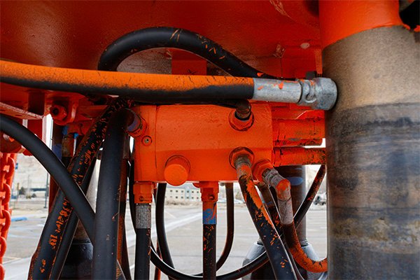 Hydraulic hoses connected to machinery, Durable hoses for heavy-duty equipment