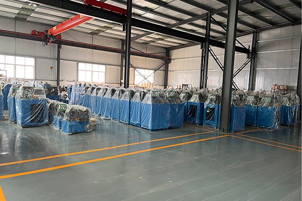 Rows of packaged hydraulic machines covered in protective material, emphasizing readiness for shipment