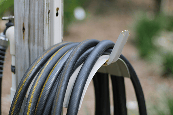 Hose storage on a metal hanger, organized hydraulic hose display