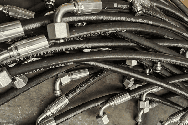 Close-up of hydraulic hoses with fittings, high-pressure hose connections