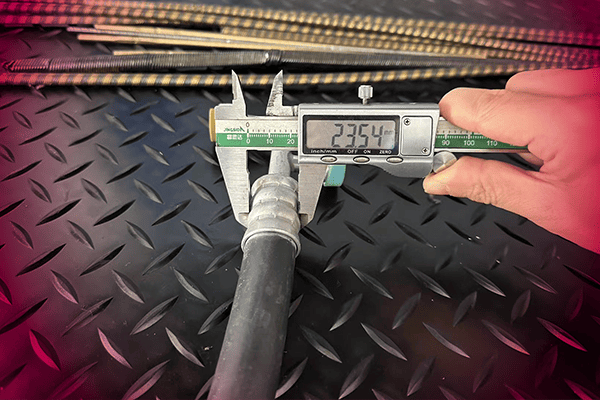 Measuring hydraulic hose diameter with caliper, precision quality control