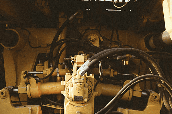Heavy machinery hydraulic system with connected hoses and fittings