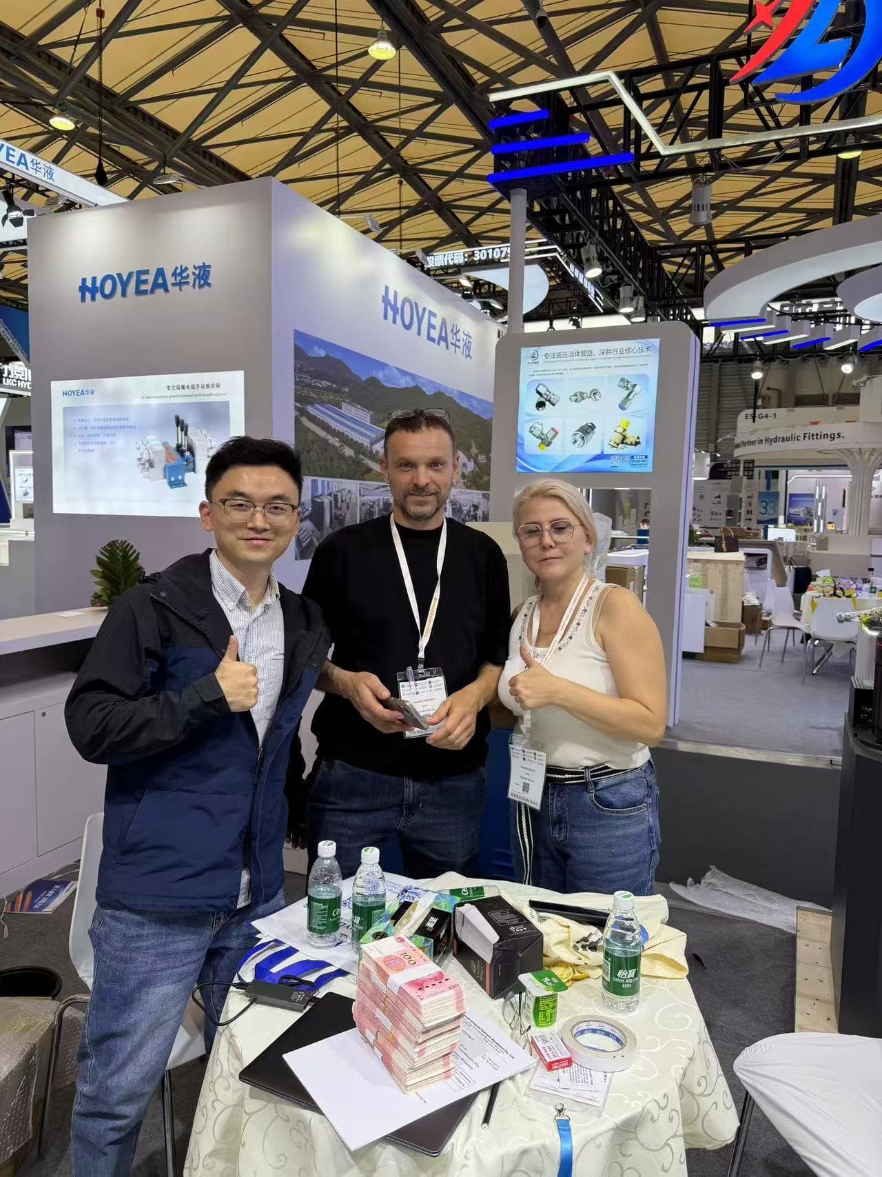 Exhibition photo with customers, Product discussion at a trade show booth